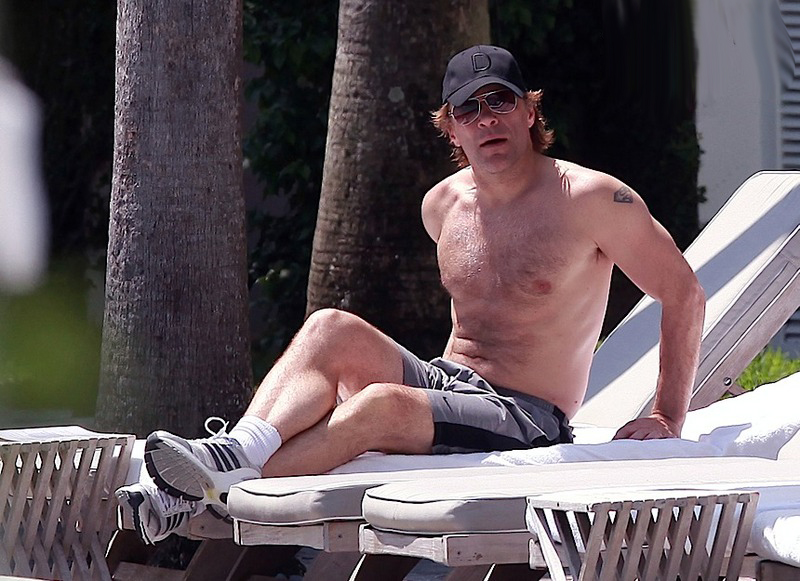 Jon Bon Jovi sunbathes on a beach