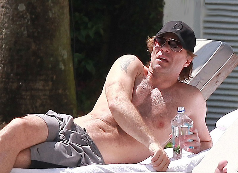 Jon Bon Jovi sunbathes on a beach